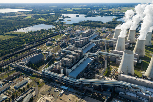 Aerial view of the Janschwalde Power Station with its cooling towers emitting steam plumes surrounded by industrial infrastructure and lakes in Peitz Brandenburg Germany. Aerial view of the Janschwalde Power Station with its cooling towers emitting steam plumes surrounded by industrial infrastructure and lakes in Peitz Brandenburg Germany.