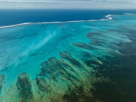 Aerial view of the vibrant turquoise waters meeting the deep blue ocean along the barrier reef a stunning display of nature s artistry Noumea South Province New Caledonia.