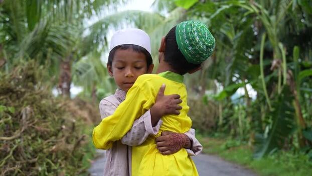 View of two young boys hugging in traditional attire Bangladesh. View of two young boys hugging in traditional attire Bangladesh.