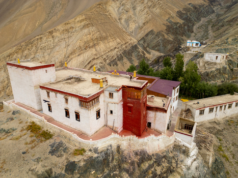 Aerial view of Zanskar Monastery nestled in the rugged mountains of the Himalayas with traditional white and red architecture stone walls and rocky terrain in Zanskar Ladakh India.