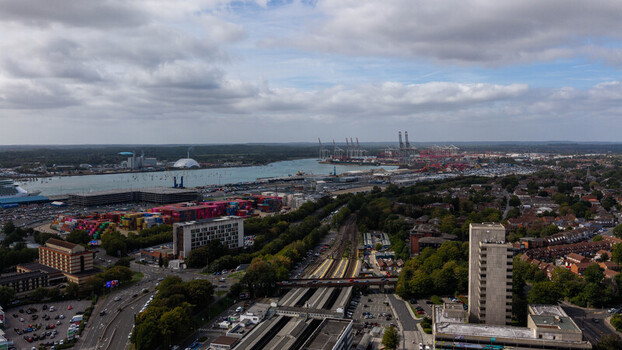 Aerial view of the busy port of Southampton with container terminals cranes industrial buildings and urban infrastructure in Southampton England United Kingdom. Aerial view of the busy port of Southampton with container terminals cranes industrial buildings and urban infrastructure in Southampton England United Kingdom.
