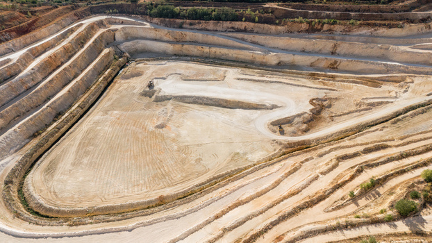 Aerial view of an open pit quarry with terraced slopes and heavy machinery in Besenovo Vojvodina Serbia. Aerial view of an open pit quarry with terraced slopes and heavy machinery in Besenovo Vojvodina Serbia.