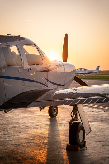 View of a private airplane parked on the tarmac at Hannover Airport during golden hour in Langenhagen Niedersachsen Germany. View of a private airplane parked on the tarmac at Hannover Airport during golden hour in Langenhagen Niedersachsen Germany.