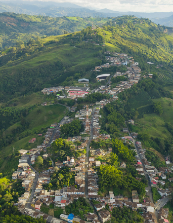 Aerial view of the town nestled amidst emerald hills and verdant landscapes a tapestry of terracotta roofs and winding streets Salamina Caldas Colombia. Aerial view of the town nestled amidst emerald hills and verdant landscapes a tapestry of terracotta roofs and winding streets Salamina Caldas Colombia.