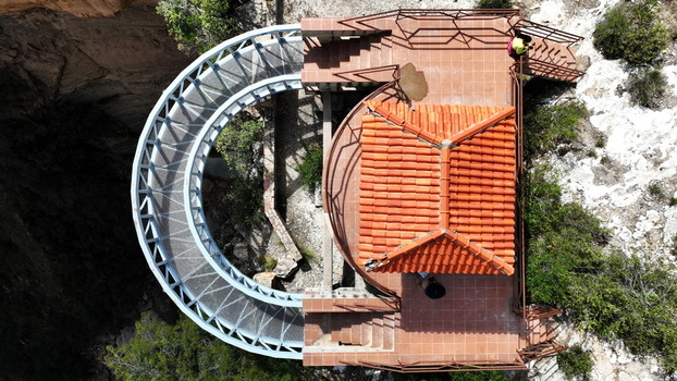 Aerial view of El Vergel viewing platform featuring a curved metal walkway and a terracotta tiled roof building situated at the edge of a canyon in Torotoro Potosi Department Bolivia. Aerial view of El Vergel viewing platform featuring a curved metal walkway and a terracotta tiled roof building situated at the edge of a canyon in Torotoro Potosi Department Bolivia.