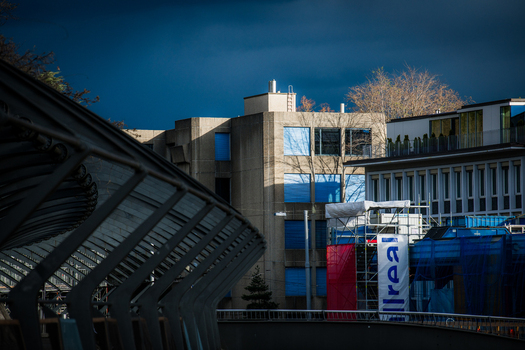 Zurich Switzerland 02 April 2023 View of modern architecture juxtaposed against a dramatic brooding sky as seen from an elevated walkway overlooking buildings with vibrant blue accents. Zurich Switzerland 02 April 2023 View of modern architecture juxtaposed against a dramatic brooding sky as seen from an elevated walkway overlooking buildings with vibrant blue accents.