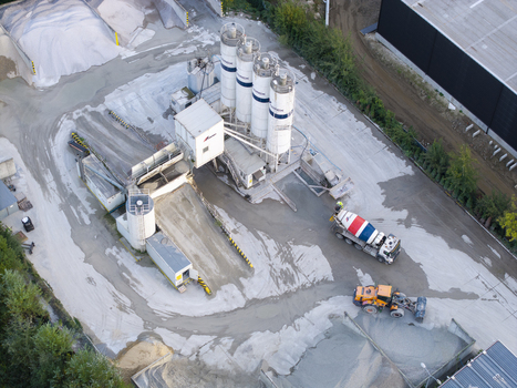 Krakow Malopolska Poland 16 September 2026 Aerial view of CEMEX concrete plant with storage silos a concrete mixer truck and heavy machinery in an industrial facility. Krakow Malopolska Poland 16 September 2026 Aerial view of CEMEX concrete plant with storage silos a concrete mixer truck and heavy machinery in an industrial facility.