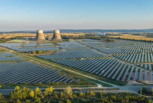 Aerial view of a large scale photovoltaic solar farm surrounding former industrial cooling towers in the rural landscape of Trino Piedmont Italy. Aerial view of a large scale photovoltaic solar farm surrounding former industrial cooling towers in the rural landscape of Trino Piedmont Italy.
