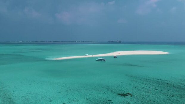 Aerial view of a white sandbank and boats in clear water Maldives. Aerial view of a white sandbank and boats in clear water Maldives.