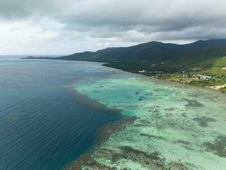 Aerial view of the coast where the deep blue sea meets the vibrant turquoise waters Karimunjawa Central Java Indonesia. Aerial view of the coast where the deep blue sea meets the vibrant turquoise waters Karimunjawa Central Java Indonesia.