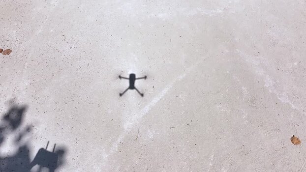 Aerial view of a drone shadow on white sand Maldives. Aerial view of a drone shadow on white sand Maldives.