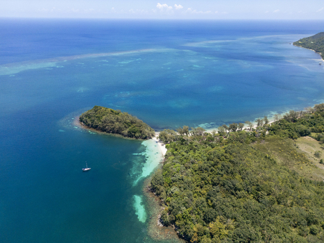 Aerial view of the lush tropical forest and coral reefs surrounding Guanaja Bay Islands Department Honduras. Aerial view of the lush tropical forest and coral reefs surrounding Guanaja Bay Islands Department Honduras.