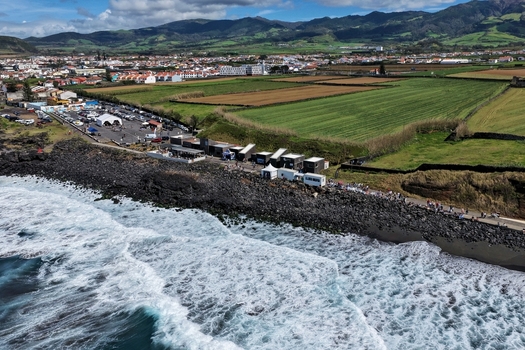 Aerial view of Praia do Areal de Santa Barbara with crashing waves on volcanic rocks and green fields in Ribeira Grande Acores Portugal. Aerial view of Praia do Areal de Santa Barbara with crashing waves on volcanic rocks and green fields in Ribeira Grande Acores Portugal.