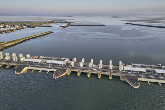 Den Oever Noord Holland Netherlands 19 June 2026 Aerial view of Stevinsluizen sluice dam renewal with new fish friendly pumping stations in early morning light. Den Oever Noord Holland Netherlands 19 June 2026 Aerial view of Stevinsluizen sluice dam renewal with new fish friendly pumping stations in early morning light.
