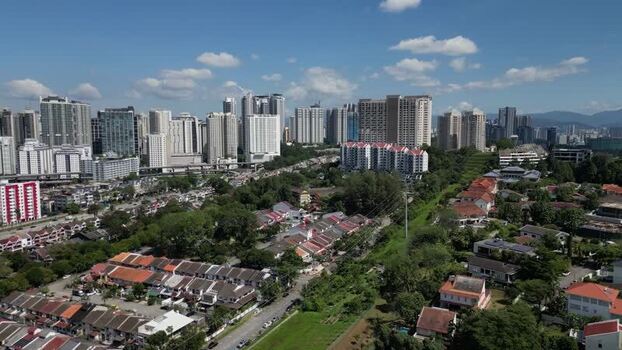 Aerial view of the Kuala Lumpur skyline and residential houses in Malaysia. Aerial view of the Kuala Lumpur skyline and residential houses in Malaysia.