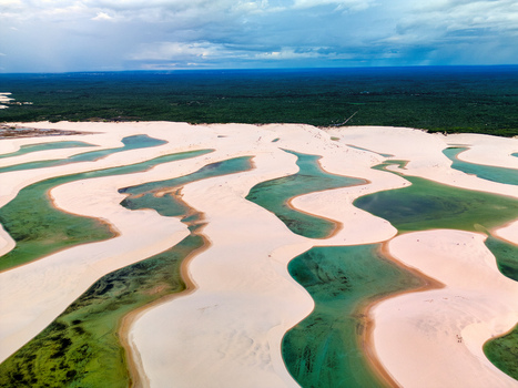 Aerial view of Lagoa Bonita with its iconic white sand dunes and crystal clear turquoise rainwater lagoons surrounded by lush vegetation in Barreirinhas State of Maranhao Brazil. Aerial view of Lagoa Bonita with its iconic white sand dunes and crystal clear turquoise rainwater lagoons surrounded by lush vegetation in Barreirinhas State of Maranhao Brazil.