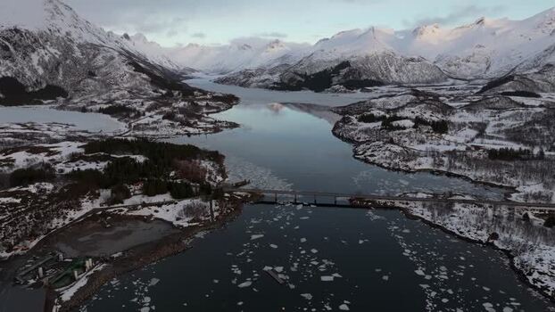Aerial view of Lofoten bridge in snowy winter landscape Norway.