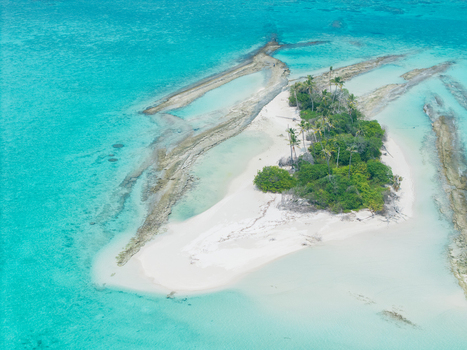 Aerial view of a secluded island paradise where turquoise waters meet the pristine white sand beach and lush greenery Thuraakunu Thiladhunmathee Uthuruburi Maldives. Aerial view of a secluded island paradise where turquoise waters meet the pristine white sand beach and lush greenery Thuraakunu Thiladhunmathee Uthuruburi Maldives.