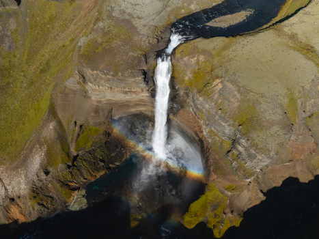 Aerial view of the cascading Háifoss waterfall plunges into the gorge displaying a vibrant rainbow against the rugged cliffs Haifoss Skeiða og Gnúpverjahreppur Iceland. Aerial view of the cascading Háifoss waterfall plunges into the gorge displaying a vibrant rainbow against the rugged cliffs Haifoss Skeiða og Gnúpverjahreppur Iceland.