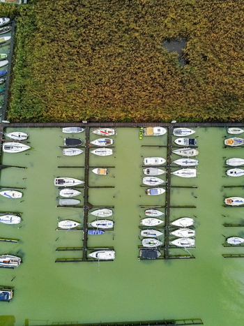 Aerial view of boats docked in the marina at Lake Neusiedl surrounded by reeds in Rust Burgenland Austria.