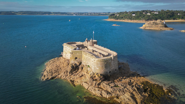 Aerial view of the ancient Chateau du Taureau fort standing majestically on rugged brown rocks amidst the deep blue sea Plouezoc h Bretagne France. Aerial view of the ancient Chateau du Taureau fort standing majestically on rugged brown rocks amidst the deep blue sea Plouezoc h Bretagne France.