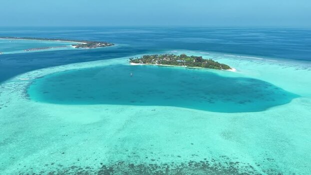 Aerial view of a tropical island and coral reefs Maldives. Aerial view of a tropical island and coral reefs Maldives.