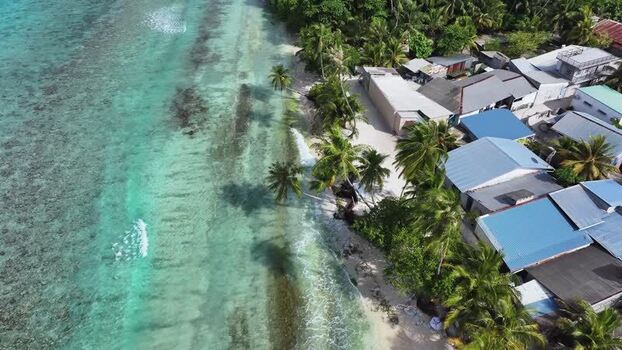 Aerial view of tropical coastline with turquoise water and houses Maldives. Aerial view of tropical coastline with turquoise water and houses Maldives.