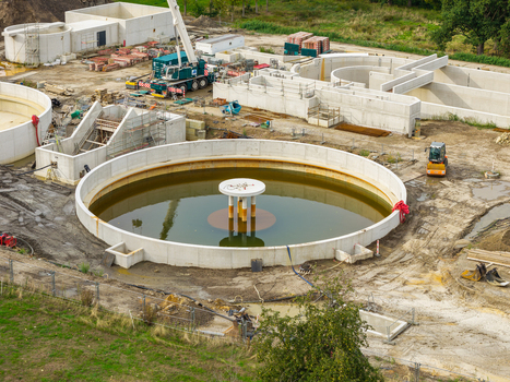 Diepenbeek Flanders Belgium 30 August 2026 Aerial view of a wastewater treatment plant under construction with circular concrete tanks and industrial machinery. Diepenbeek Flanders Belgium 30 August 2026 Aerial view of a wastewater treatment plant under construction with circular concrete tanks and industrial machinery.