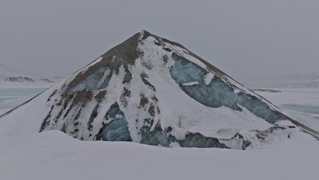 Aerial view of snow capped mountain peak in Svalbard and Jan Mayen.