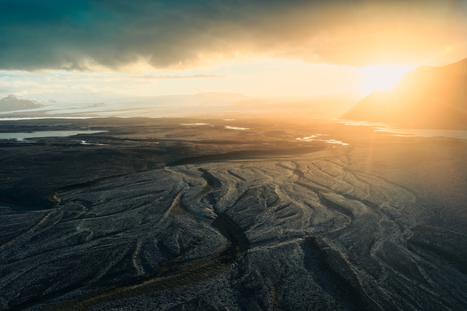 Aerial view of Jokulsarlon glacier lagoon with intricate glacial river patterns and dramatic golden hour light in Sveitarfelagid Hornafjordur Iceland. Aerial view of Jokulsarlon glacier lagoon with intricate glacial river patterns and dramatic golden hour light in Sveitarfelagid Hornafjordur Iceland.
