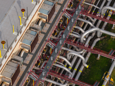 Aerial view of an industrial facility with complex silver pipelines metal walkways and corrugated rooftops in Hrusky South Moravian Region Czechia. Aerial view of an industrial facility with complex silver pipelines metal walkways and corrugated rooftops in Hrusky South Moravian Region Czechia.