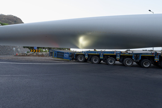 Estreito da Calheta Portugal 20 September 2026 View of a massive wind turbine blade being transported on a specialized heavy duty trailer truck along a road in Estreito da Calheta. Estreito da Calheta Portugal 20 September 2026 View of a massive wind turbine blade being transported on a specialized heavy duty trailer truck along a road in Estreito da Calheta.