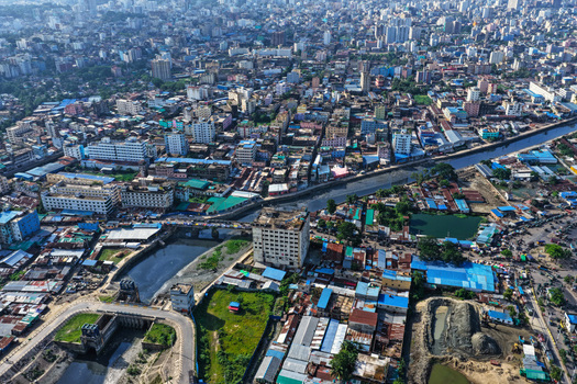 Aerial view of the Karnaphuli River winding through the dense urban landscape of Chattogram featuring buildings and bridges in Chattogram Chittagong Division Bangladesh.