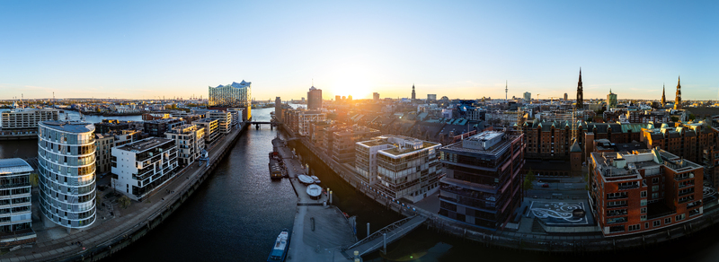 Aerial view of Speicherstadt and Elbphilharmonie with modern buildings along the canals at sunset in Hamburg Hamburg Germany. Aerial view of Speicherstadt and Elbphilharmonie with modern buildings along the canals at sunset in Hamburg Hamburg Germany.