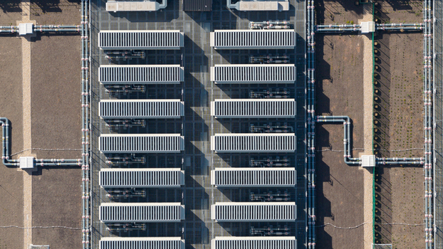 Aerial view of a modern industrial facility featuring rows of cooling units and complex piping systems in Dietzenbach Hessen Germany. Aerial view of a modern industrial facility featuring rows of cooling units and complex piping systems in Dietzenbach Hessen Germany.