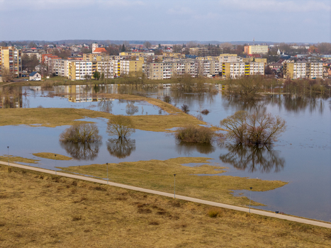 Kedainiai Lithuania 17 March 2026 Aerial view of flooded meadows and trees near residential apartment buildings under an overcast sky. Kedainiai Lithuania 17 March 2026 Aerial view of flooded meadows and trees near residential apartment buildings under an overcast sky.