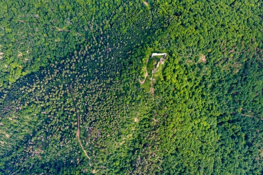 Aerial view of the ruins of Saint Ulrich castle surrounded by a dense green forest on a sunny day in Ribeauville Grand Est France. Aerial view of the ruins of Saint Ulrich castle surrounded by a dense green forest on a sunny day in Ribeauville Grand Est France.