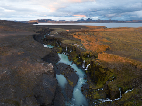 Aerial view of the glacial river carves its path through the rugged canyon cascading over moss covered ledges into turquoise pools Sigöldugljúfur Rangárþing ytra Iceland. Aerial view of the glacial river carves its path through the rugged canyon cascading over moss covered ledges into turquoise pools Sigöldugljúfur Rangárþing ytra Iceland.