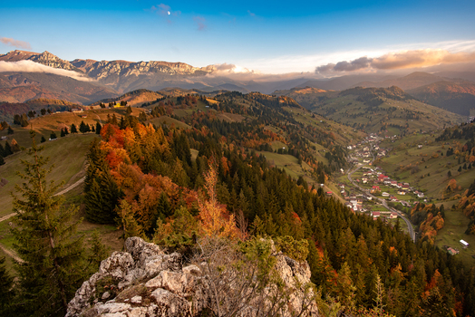 View of the autumn landscape in the Carpathian Mountains with colorful forests rolling hills and a small village nestled in the valley in Alba County Romania. View of the autumn landscape in the Carpathian Mountains with colorful forests rolling hills and a small village nestled in the valley in Alba County Romania.