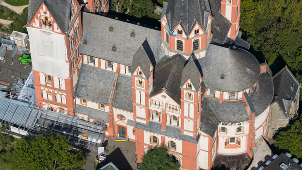 Aerial view of Limburg Cathedral with Romanesque architecture red and white stone walls and towers surrounded by scaffolding in Limburg an der Lahn Hessen Germany. Aerial view of Limburg Cathedral with Romanesque architecture red and white stone walls and towers surrounded by scaffolding in Limburg an der Lahn Hessen Germany.