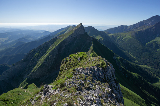 View of the sharp mountain peak of Zdiarska vidla with green grassy slopes and rocky ridges under a clear blue sky in Zdiar Presov Region Slovakia. View of the sharp mountain peak of Zdiarska vidla with green grassy slopes and rocky ridges under a clear blue sky in Zdiar Presov Region Slovakia.