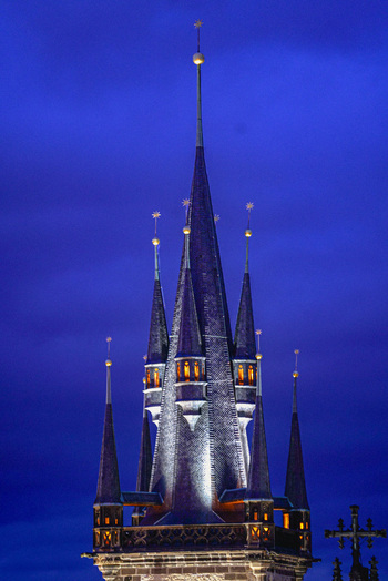 Aerial view of the illuminated gothic spires of the Church of Our Lady before Tyn against a deep blue night sky in Prague Prague Czechia. Aerial view of the illuminated gothic spires of the Church of Our Lady before Tyn against a deep blue night sky in Prague Prague Czechia.