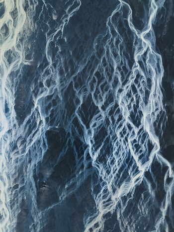 Aerial view of glacial rivers weaving through the stark icy landscape a symphony of white and blue creating an ethereal tapestry. Iceland Iceland. Aerial view of glacial rivers weaving through the stark icy landscape a symphony of white and blue creating an ethereal tapestry. Iceland Iceland.