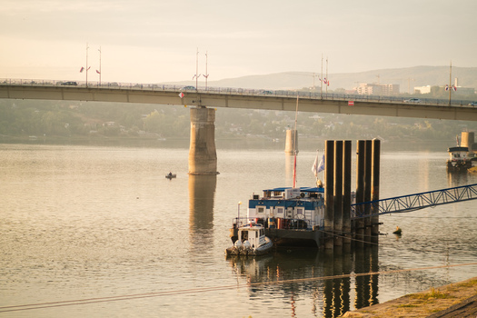 View of the Danube river with a floating boat structure and the bridge in the background in Novi Sad Vojvodina Serbia. View of the Danube river with a floating boat structure and the bridge in the background in Novi Sad Vojvodina Serbia.
