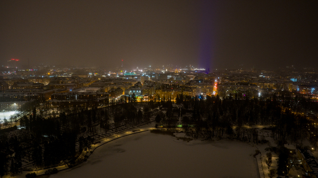 Aerial view of the illuminated Toolo district at night featuring snow covered parkland urban architecture and glowing city lights in Helsinki Uusimaa Finland. Aerial view of the illuminated Toolo district at night featuring snow covered parkland urban architecture and glowing city lights in Helsinki Uusimaa Finland.