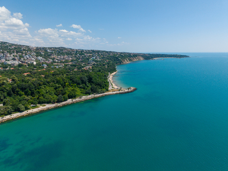 Aerial view of Alley First along the Black Sea coastline with lush greenery urban buildings and clear blue water in Varna Varna Bulgaria. Aerial view of Alley First along the Black Sea coastline with lush greenery urban buildings and clear blue water in Varna Varna Bulgaria.