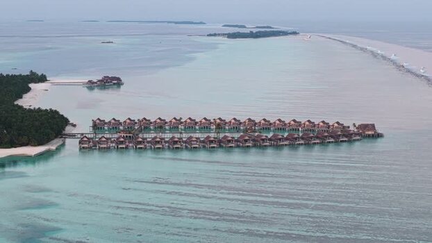 Aerial view of overwater bungalows and turquoise lagoon Maldives. Aerial view of overwater bungalows and turquoise lagoon Maldives.