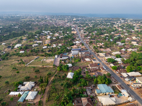 Aerial view of a ribbon of road cutting through a landscape dotted with buildings and lush greenery Elu Abia Nigeria. Aerial view of a ribbon of road cutting through a landscape dotted with buildings and lush greenery Elu Abia Nigeria.