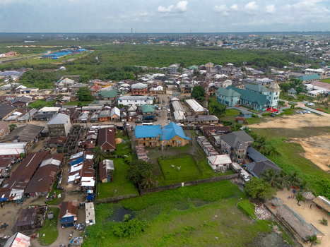 Aerial view of Bonny Island featuring residential buildings a prominent church with a blue roof and lush greenery in Bonny Town Rivers Nigeria. Aerial view of Bonny Island featuring residential buildings a prominent church with a blue roof and lush greenery in Bonny Town Rivers Nigeria.