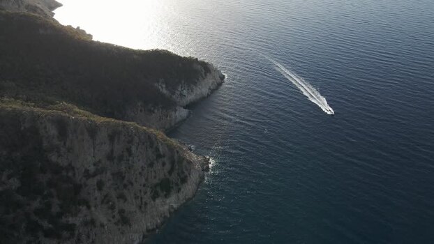 Aerial View of a motorboat sailing along the coastline in Marciana Marina Elba Island Italy.
